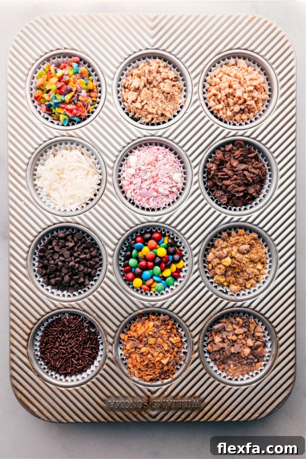 Chocolate-Covered Strawberry Dessert Bar Image of a muffin pan with all the ingredients used to dip the strawberries for Chocolate-Covered Strawberry Dessert Bar in the various wells, ready for customization.