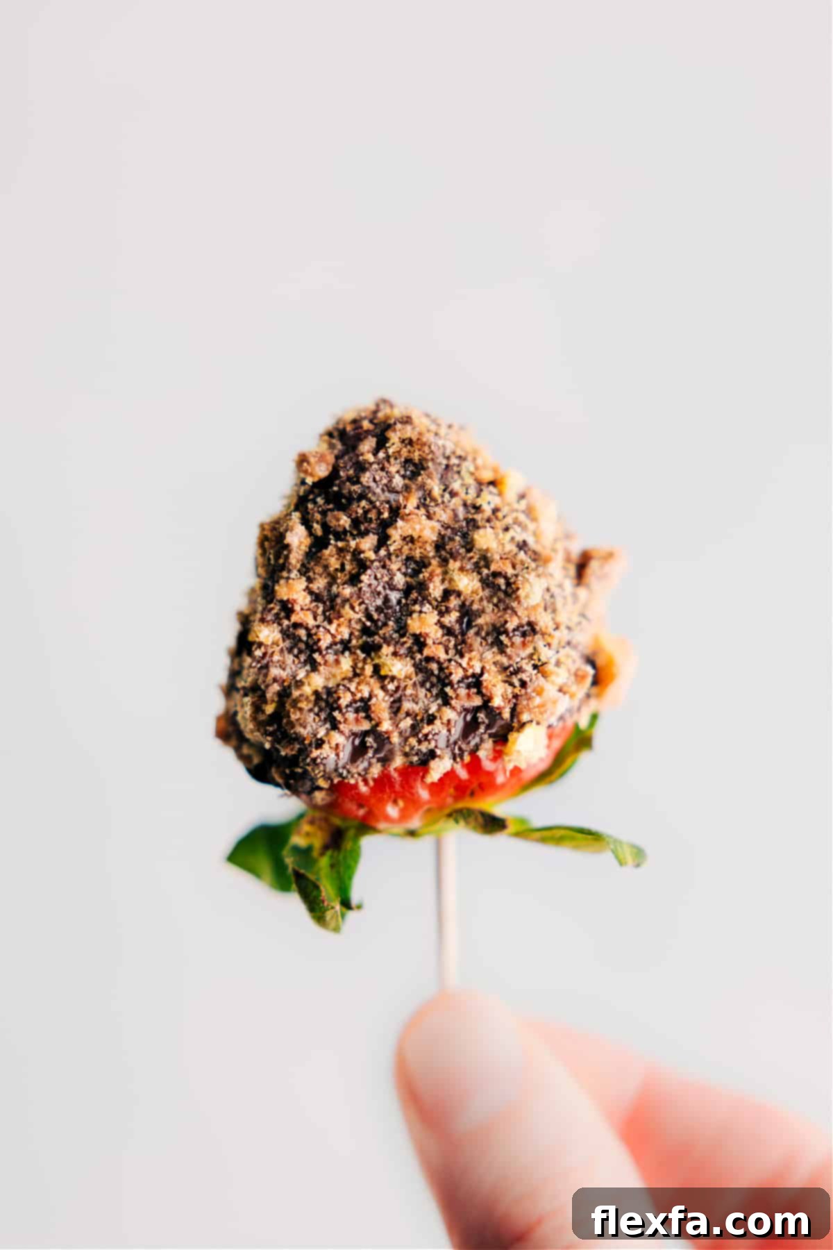Dipped Strawberries Image of a chocolate-dipped strawberry topped with cookie crumbs, beautifully prepared and ready to eat.
