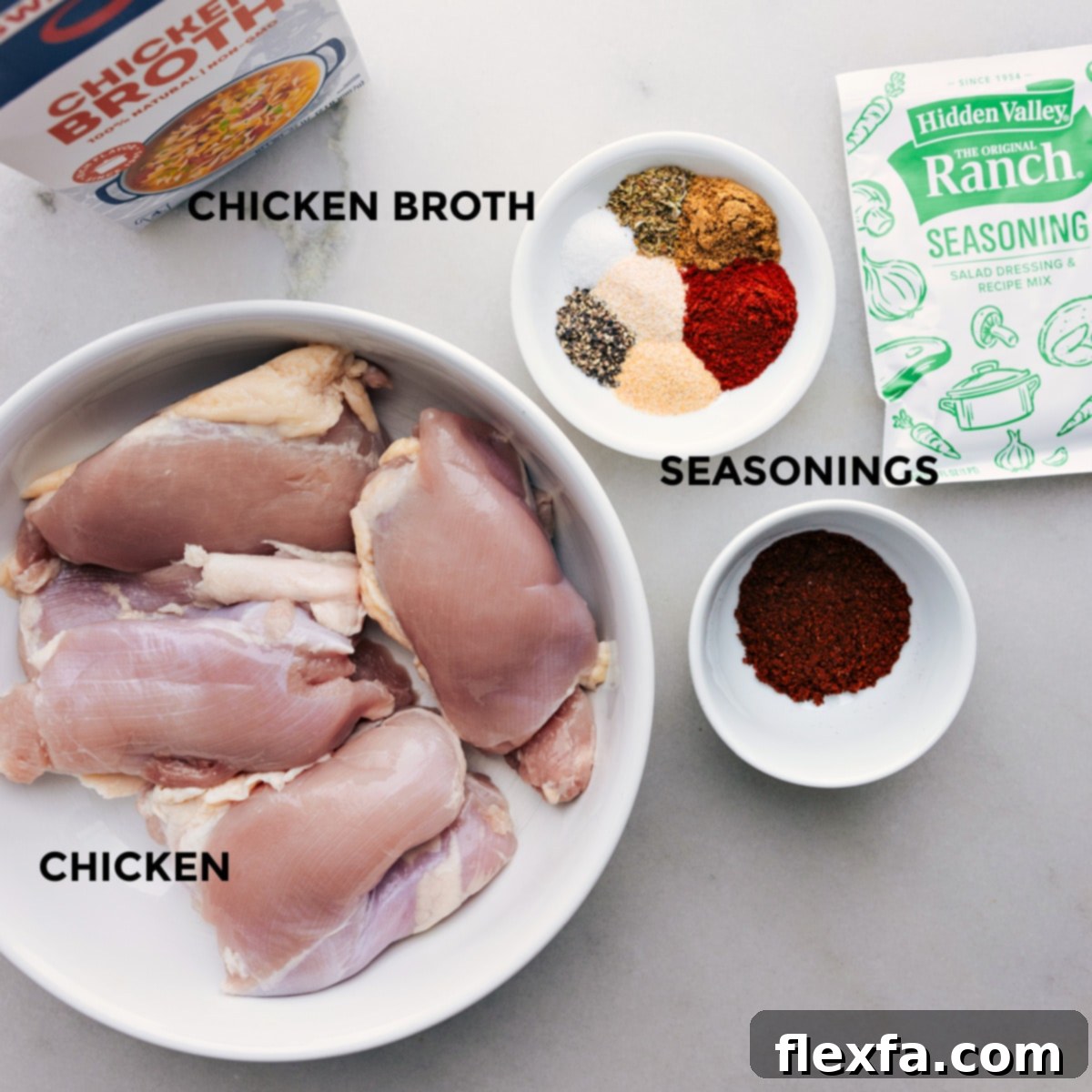 Our Favorite Chicken Tacos Ingredients Ingredients for Crockpot Chicken Tacos laid out for easy preparation including spices, broth, and chicken thighs.