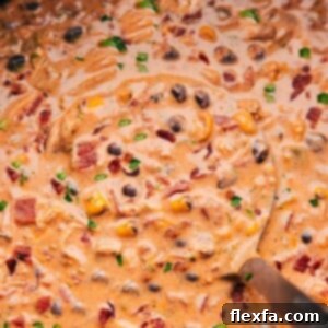 Crack Crockpot Chili with a ladle picking some up.