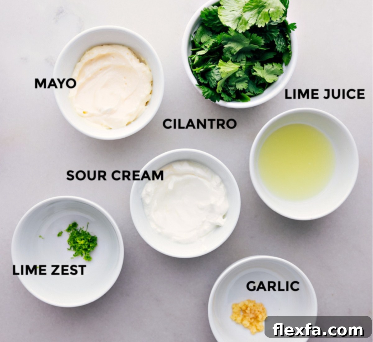Mexican Salad Dressing Ingredients Ingredients for the homemade Cilantro-Lime Dressing, including fresh limes, garlic, cilantro, jalapeño, mayo, and sour cream, prepped and ready for blending.