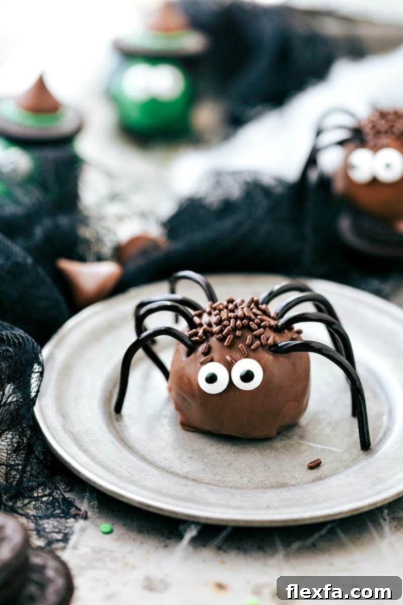 Creepy yet cute Spider Oreo Truffles with edible eyes, licorice legs, and brown sprinkles, for a Halloween party.