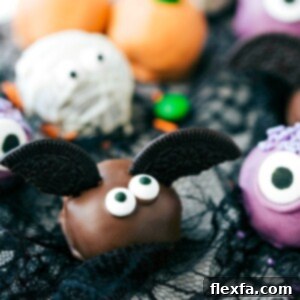 A collection of Halloween Oreo Truffles including monsters, pumpkins, and bats, arranged invitingly.