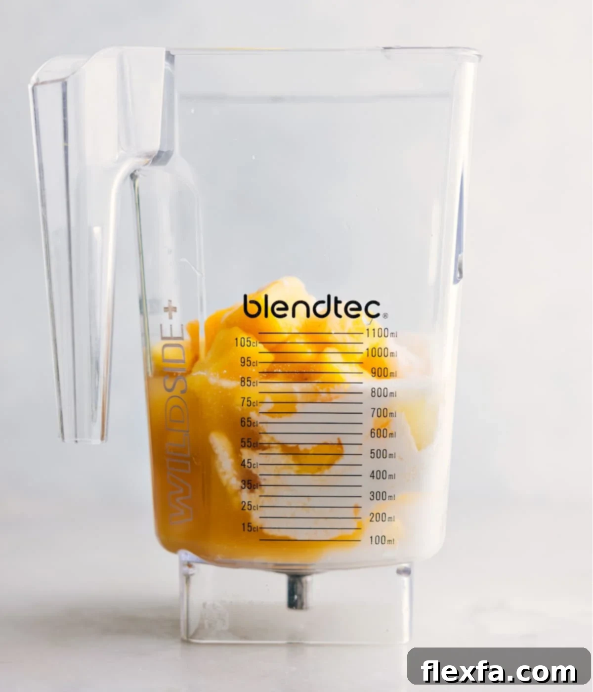 Making Pina Colada In Blender All the Pina Colada ingredients, including pineapple juice, frozen pineapple, ice cubes, cream of coconut, heavy cream, and lime, are added to a high-powered blender, ready for blending.