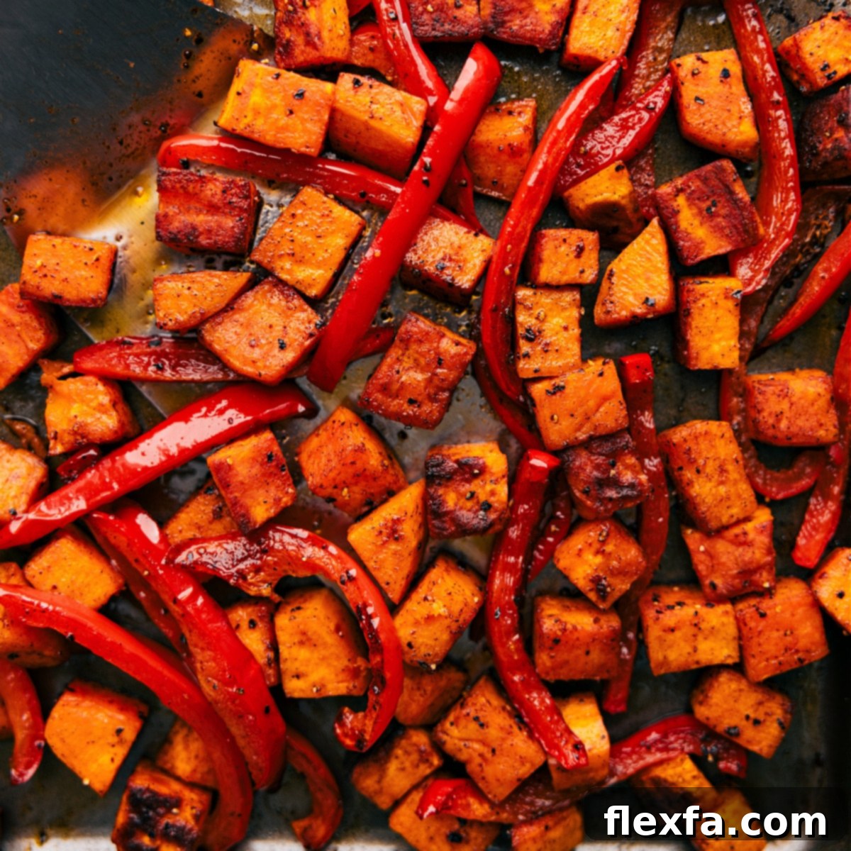 Freshly roasted potatoes and peppers Tray of freshly roasted potatoes and peppers, golden brown and sizzling straight out of the oven.