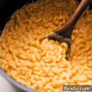 A serving of creamy one-pot mac and cheese in a bowl, showing its rich, golden texture.