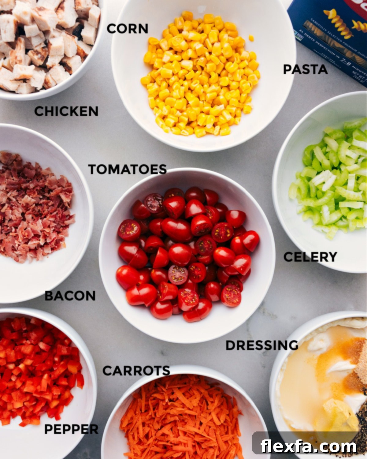 Ingredients For Chicken Pasta Salad Perfection All the fresh ingredients for Chicken Pasta Salad prepped and neatly laid out for easy assembly in the kitchen.