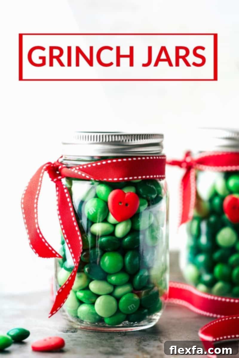 A festive collection of Grinch-themed Christmas mason jars, filled with green candies and decorated with red ribbons and heart buttons, perfect for holiday gifting.
