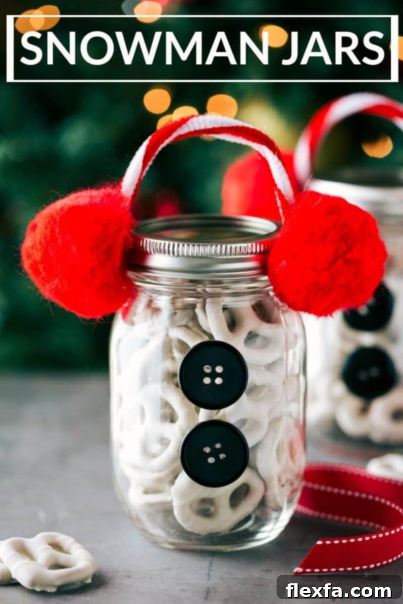 Charming Snowman-themed Christmas Mason Jars, filled with white chocolate-covered pretzels and adorned with pipe cleaner earmuffs, red pom-poms, and black buttons.