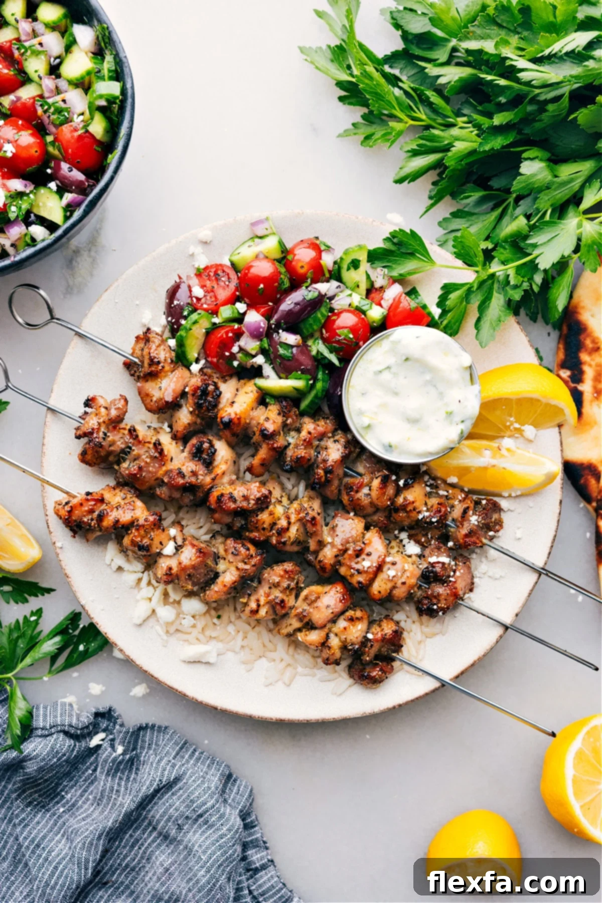 Easy Greek Chicken Bowls: A Flavorful and Healthy Meal A beautifully arranged Greek Chicken Bowl on a plate, featuring succulent chicken, a vibrant Greek salad, creamy tzatziki dressing, all served over fluffy rice.