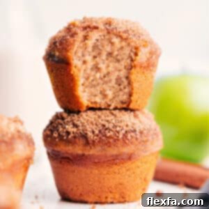 A stack of perfectly baked applesauce muffins with a generous cinnamon-sugar topping.