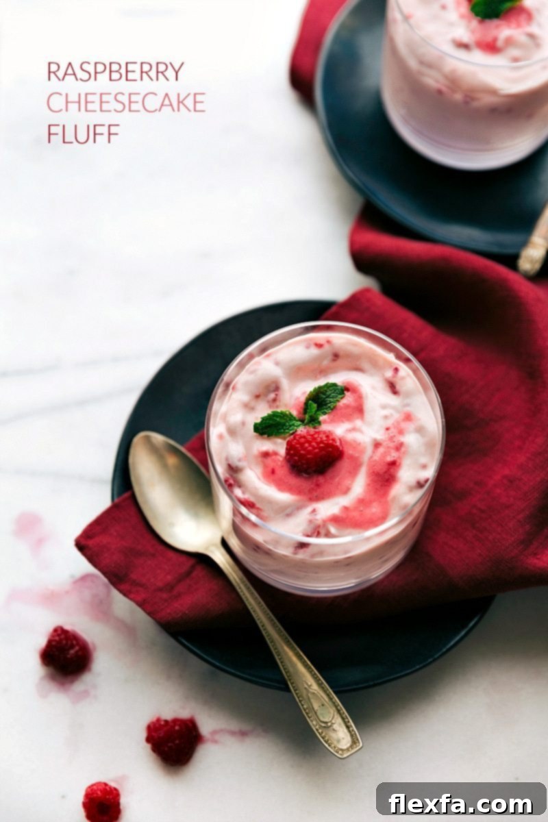 Overhead shot of a cup filled with creamy Raspberry Fluff dessert, garnished for serving