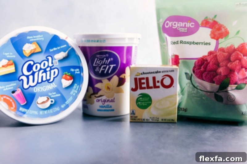All four essential ingredients laid out for Raspberry Fluff: vanilla yogurt, cheesecake pudding mix, frozen raspberries, and thawed whipped topping.