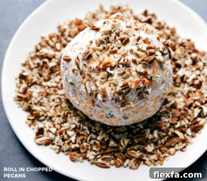 Rolling the cheese ball in chopped pecans to make the already delicious snack even more beautiful.