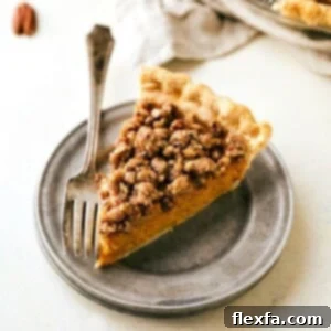 A visually appealing image of the Pecan Streusel Pumpkin Pie, showcasing its golden crust, creamy filling, and crunchy topping, a perfect representation of the finished dessert.