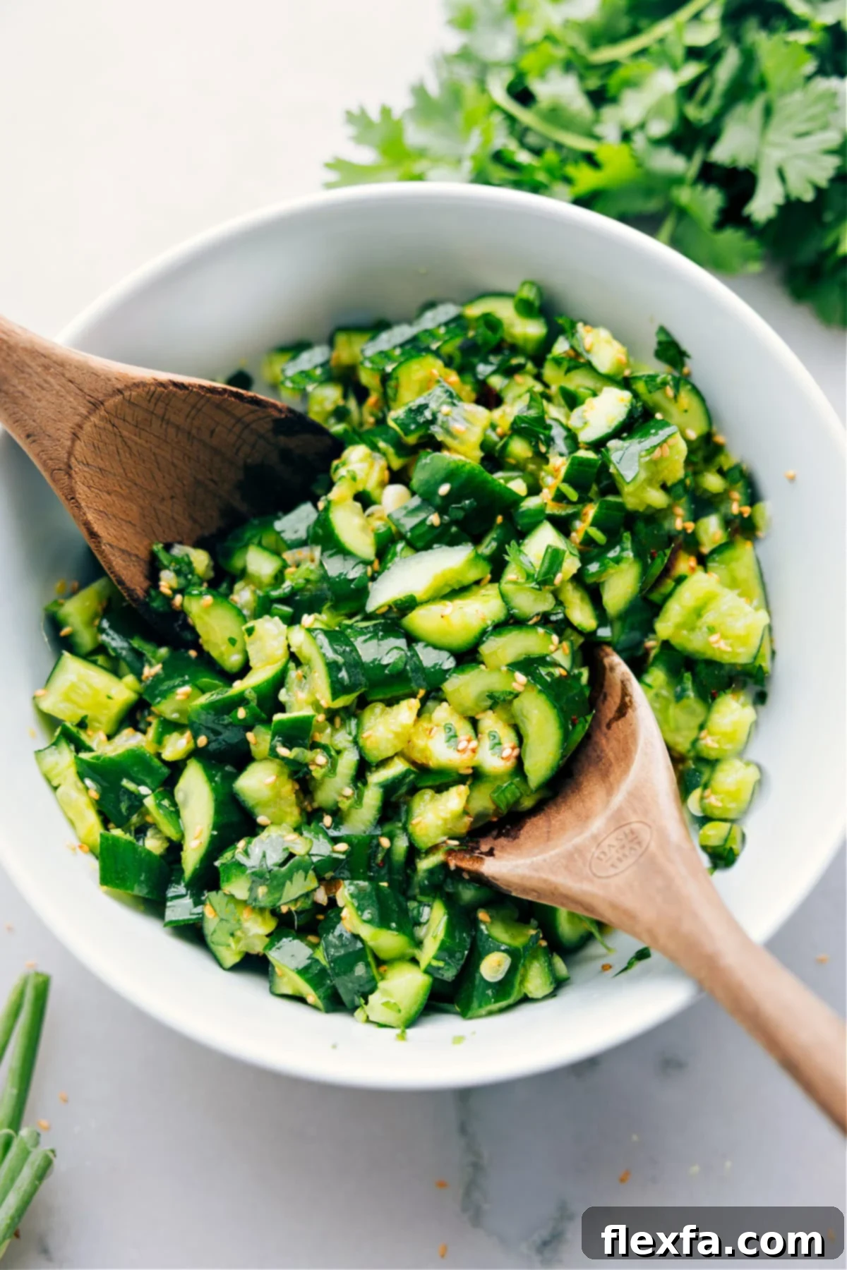 A bowl of vibrant Smashed Cucumber Salad, perfectly dressed and garnished, ready to be served.