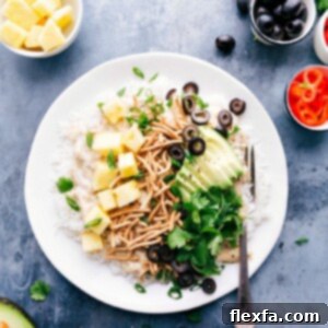 Hawaiian Haystacks, a plate loaded with salad bar toppings, surrounded by additional ingredients.