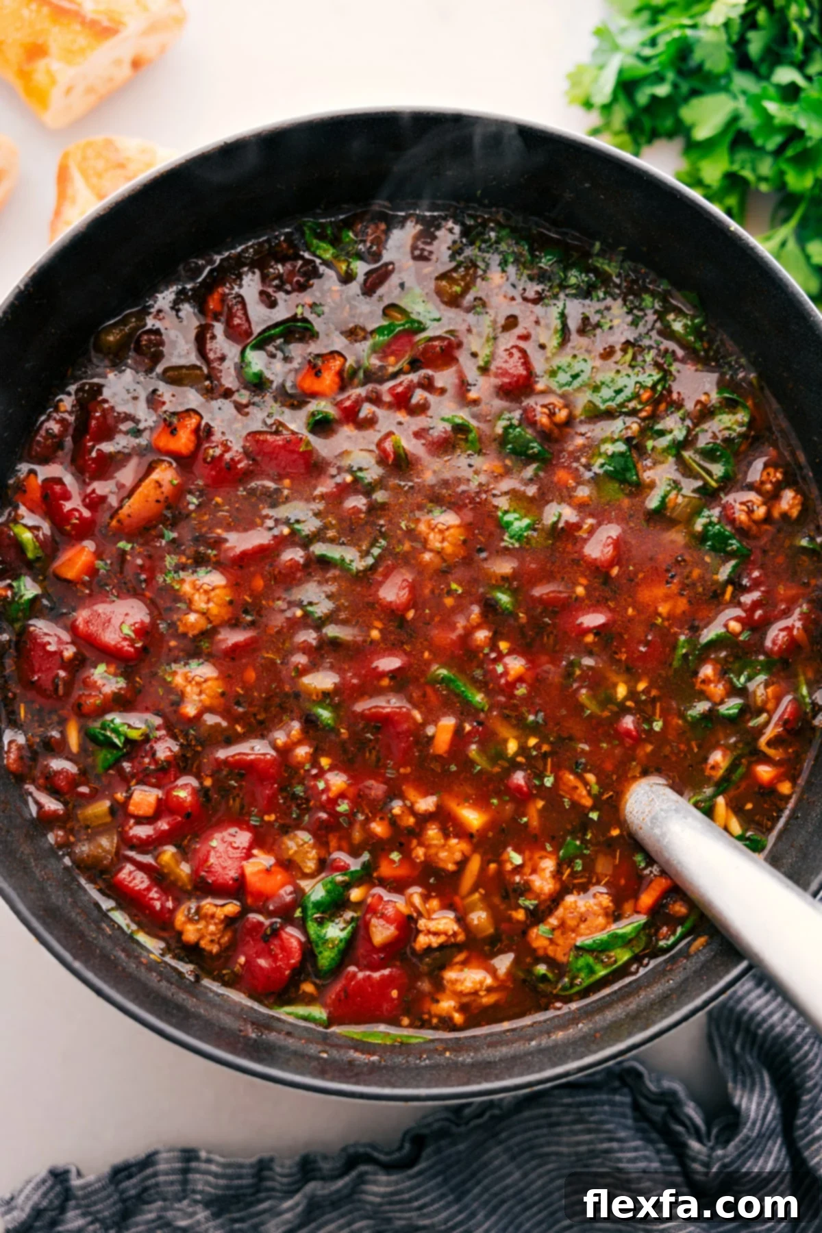 The fully cooked Italian Sausage Orzo Soup, tender and vibrant with all its ingredients, resting in a large pot, steaming gently and perfectly ready to be served and enjoyed with loved ones.