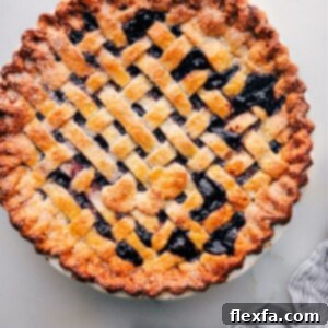 Freshly baked berry pie made with the best pie crust recipe, ready to be served.
