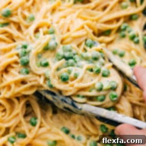 Delicious Cheesy Spaghetti garnished with fresh herbs, ready for serving.
