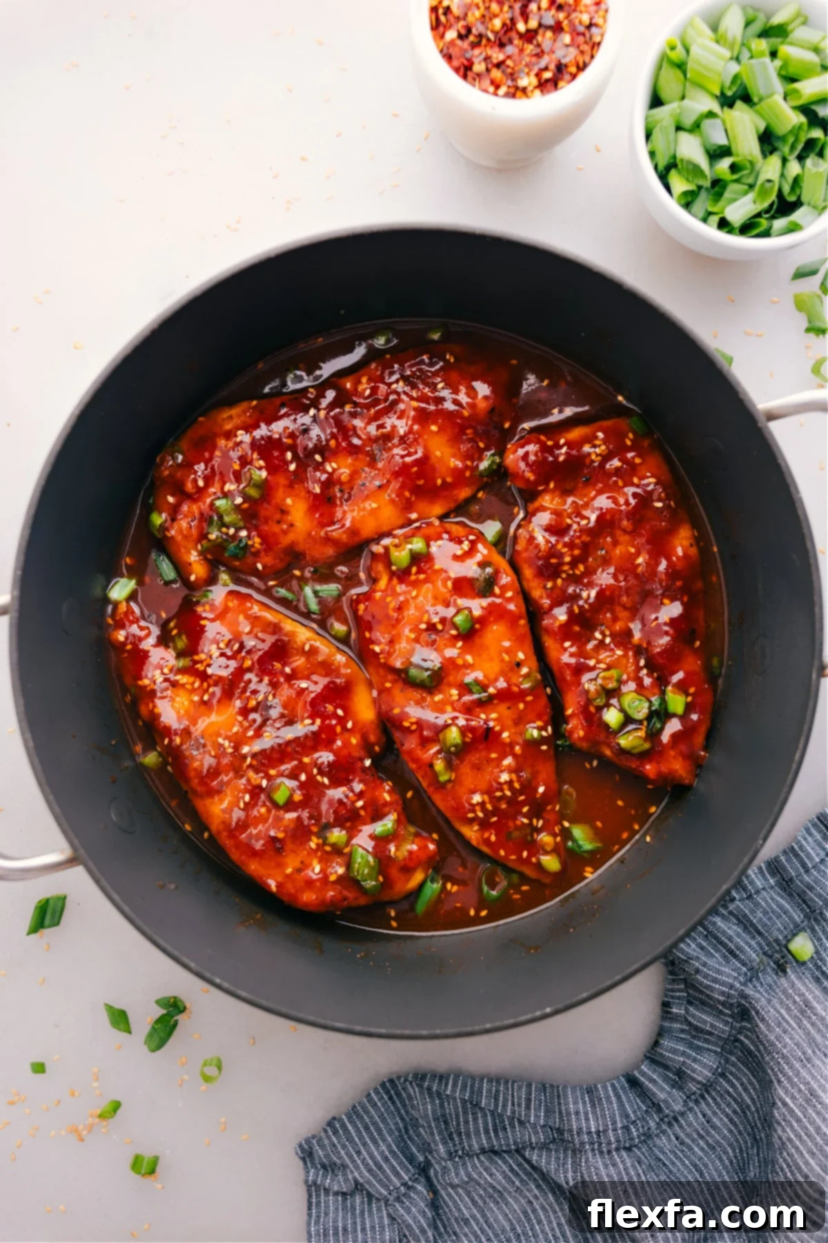 The Best And Easiest Honey Garlic Chicken Honey Garlic Chicken cooks in a skillet and gets a topping of green onions.