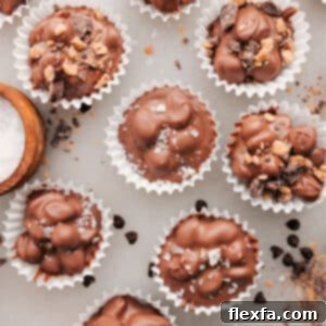 A batch of Crockpot Candy clusters, showcasing their irregular yet appealing shapes and the rich texture of chocolate and peanuts.