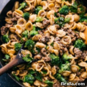 Delicious Broccoli Sausage Pasta, garnished with fresh parsley and Parmesan cheese.