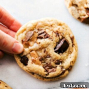 Freshly baked Toffee Cookies held in hand, golden brown and enticing.