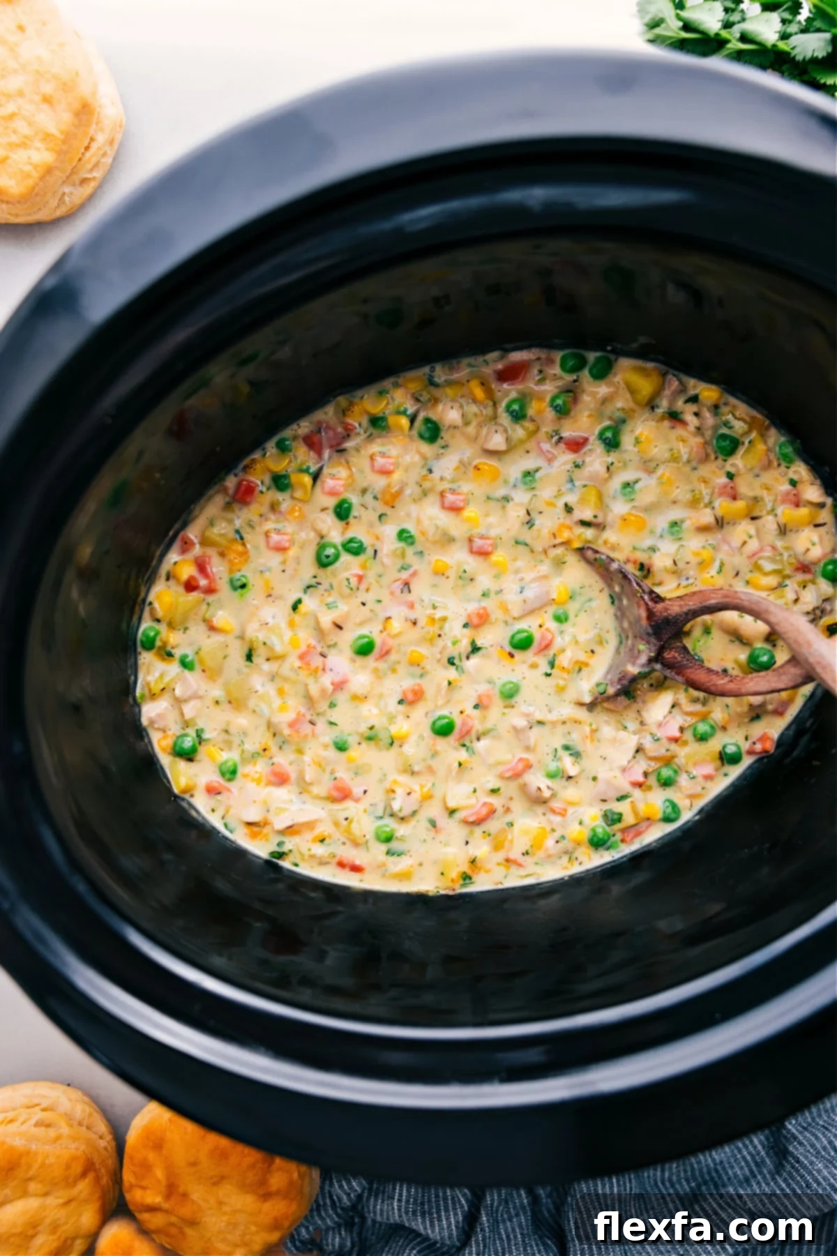 A golden-brown Crockpot Chicken Pot Pie, garnished with fresh herbs, ready to be served and enjoyed, embodying ultimate comfort.