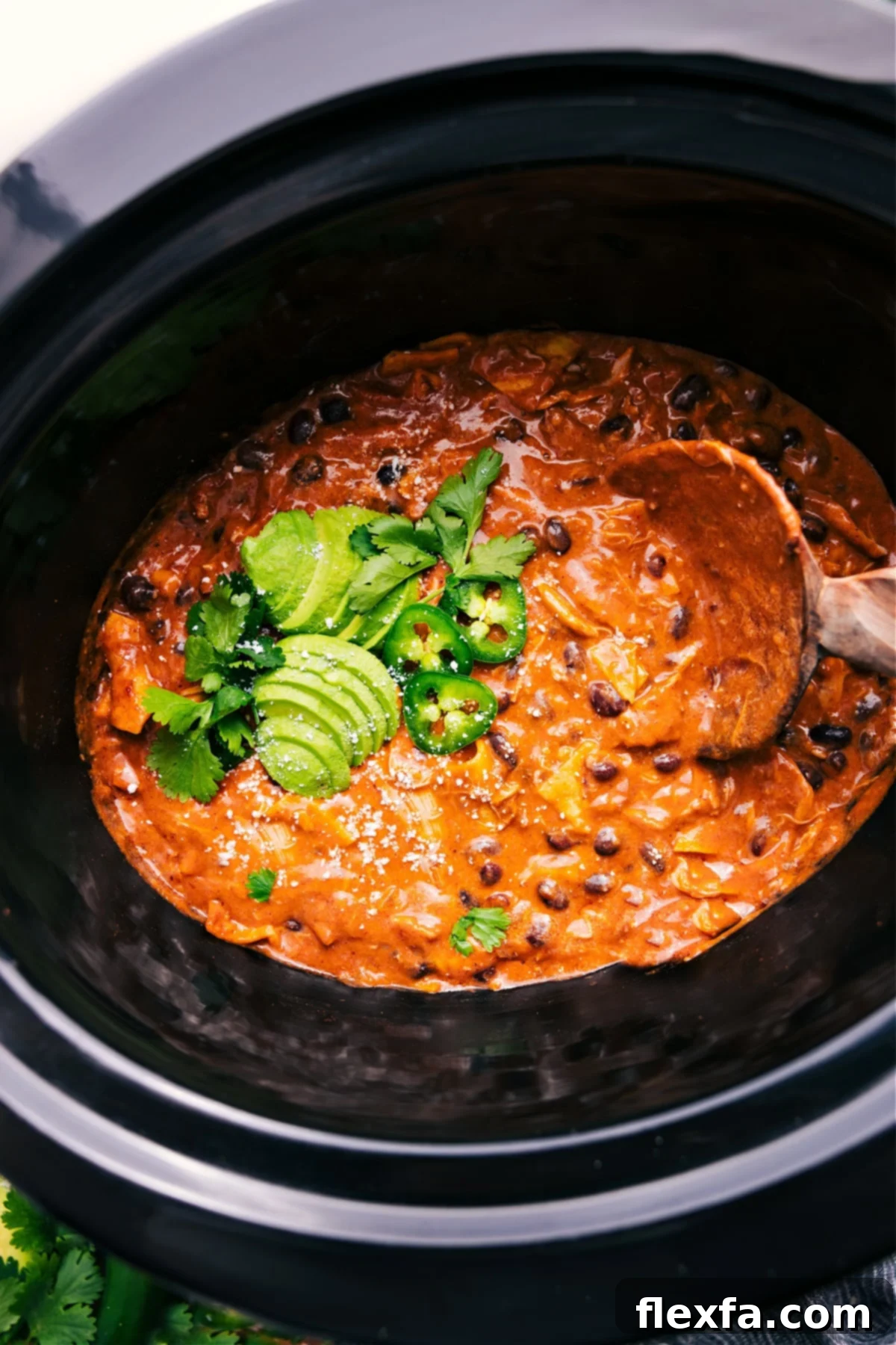 Delicious Crockpot Chicken Enchilada Casserole Ready to Serve A bubbling Crockpot Chicken Enchilada Casserole, rich with sauce and melted cheese, cooked to perfection in the slow cooker.