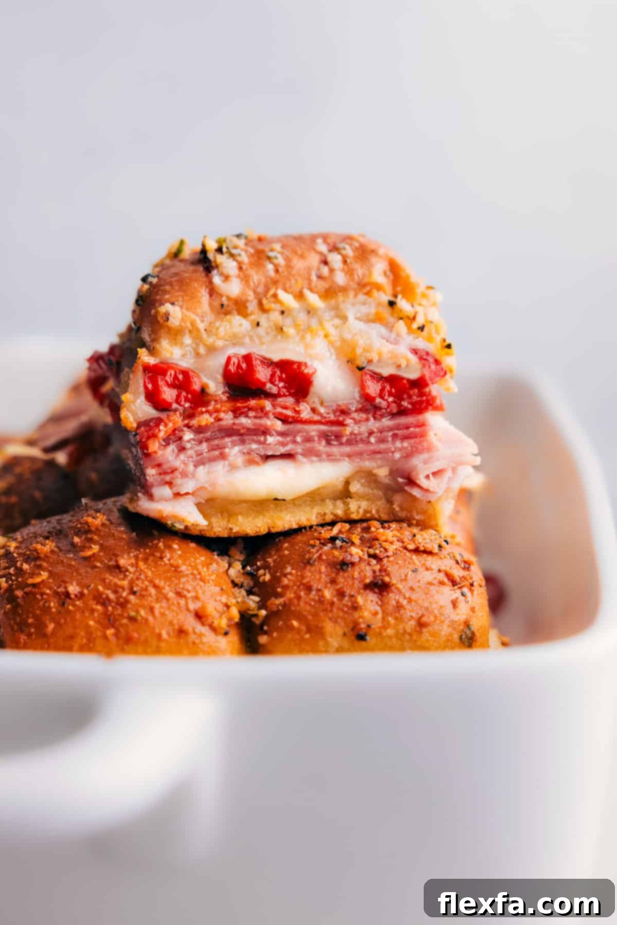 Freshly baked Italian Sliders, golden brown and cheesy, straight out of the oven.
