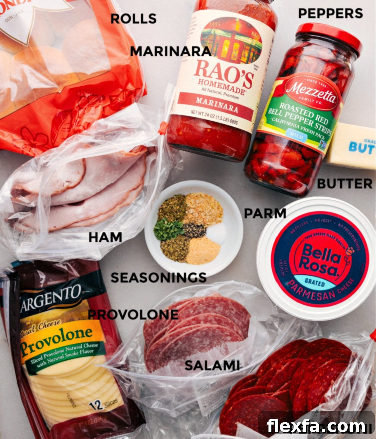 All the fresh ingredients for Italian Sliders prepped and laid out for easy assembly, including Hawaiian rolls, deli meats, cheese, and roasted red peppers.