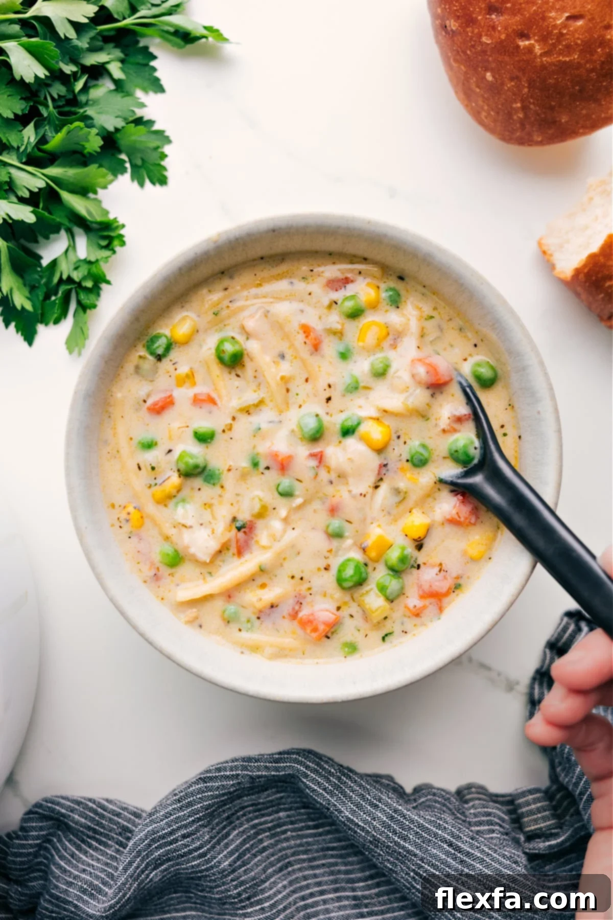 Flavorful Creamy Chicken Noodle Soup with Vegetables A steaming bowl of Creamy Chicken Noodle Soup, garnished with fresh herbs, ready to be enjoyed on a chilly day.