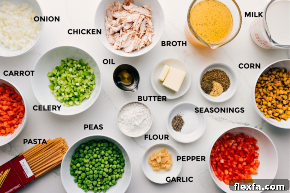 Ingredients In Creamy Chicken Noodle Soup Recipe A vibrant selection of prepped ingredients for creamy chicken noodle soup, including diced onion, carrots, celery, bell pepper, cooked chicken, spaghetti, frozen peas, corn, butter, olive oil, garlic, and various seasonings, ready for cooking.