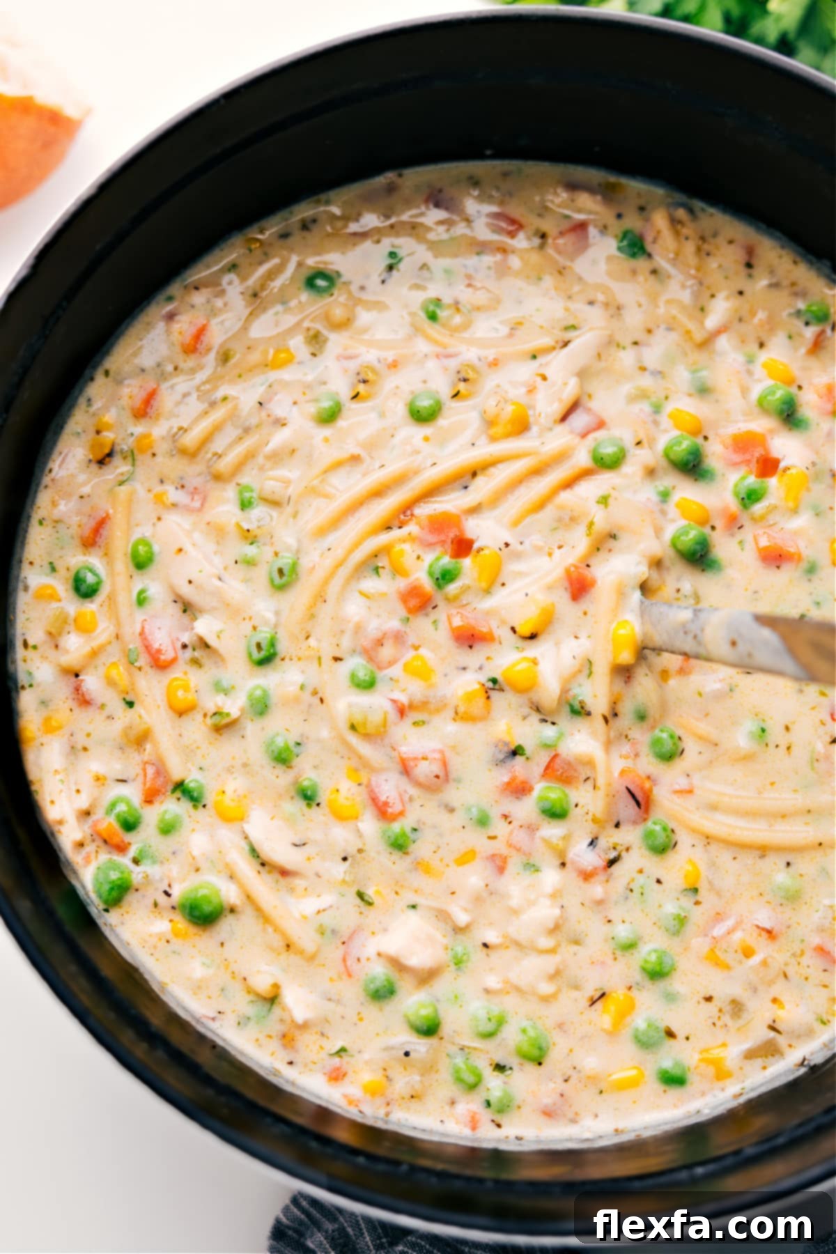 One Pot Creamy Chicken Noodle Soup Recipe A large pot filled with the finished Creamy Chicken Noodle Soup, steaming gently, ready to be served and enjoyed by the family.