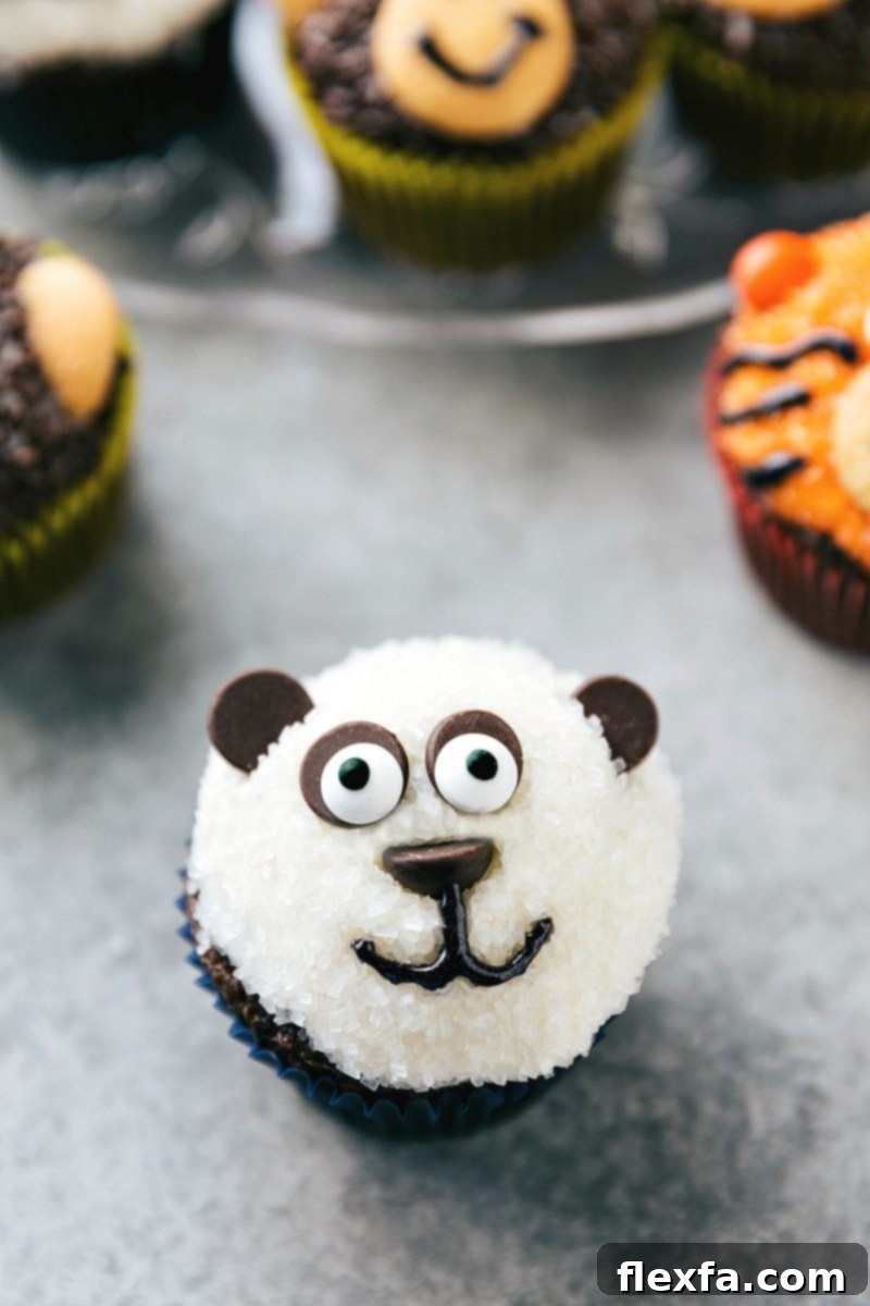 EASY JUNGLE CUPCAKES! An utterly adorable panda cupcake with white sparkling sugar, dark chocolate chip ears and eye sockets, and edible candy eyes, created by chelseasmessyapron.com