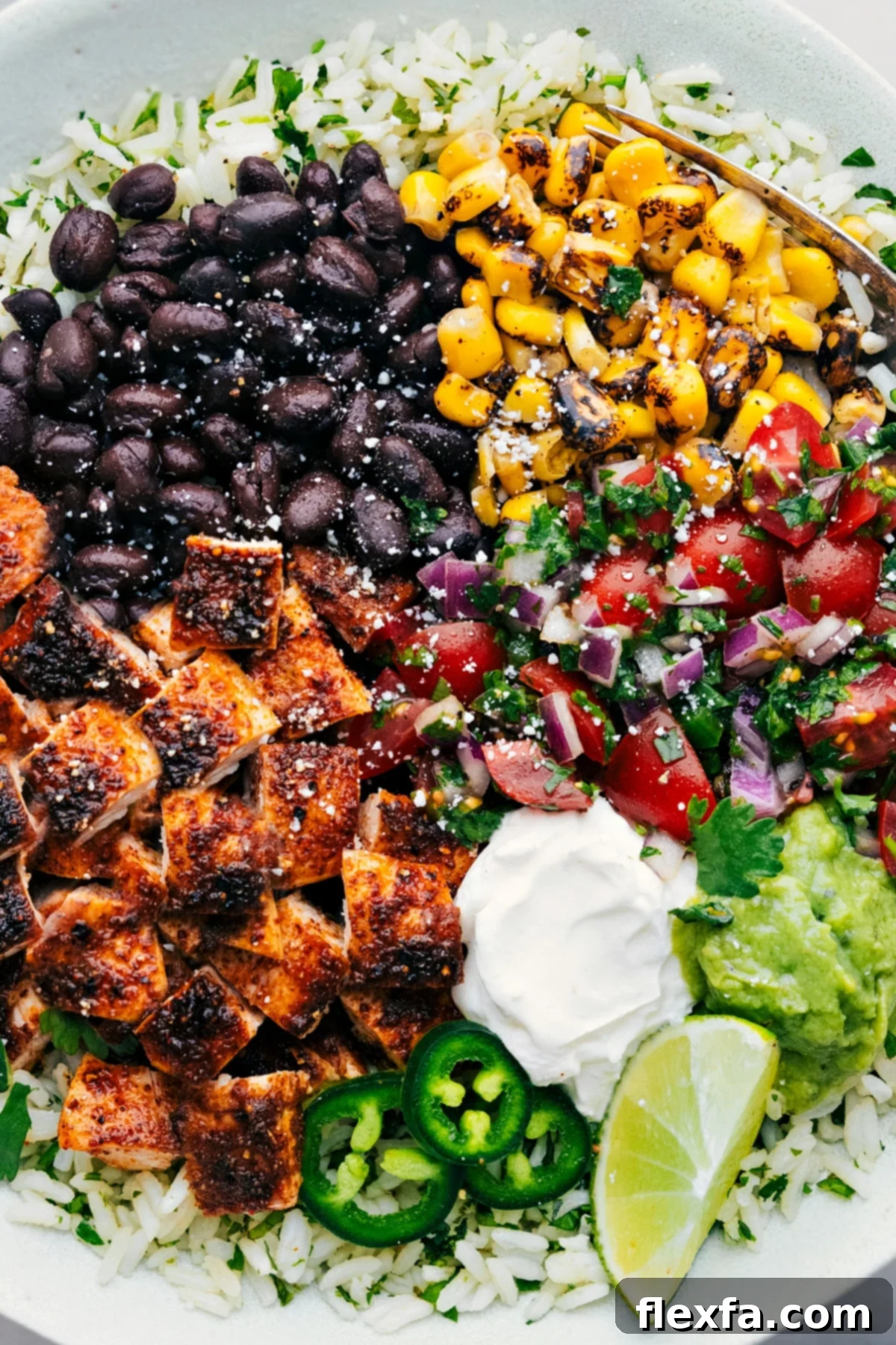 Multiple Chicken Burrito Bowls, fully loaded with all available toppings, ready to be served.