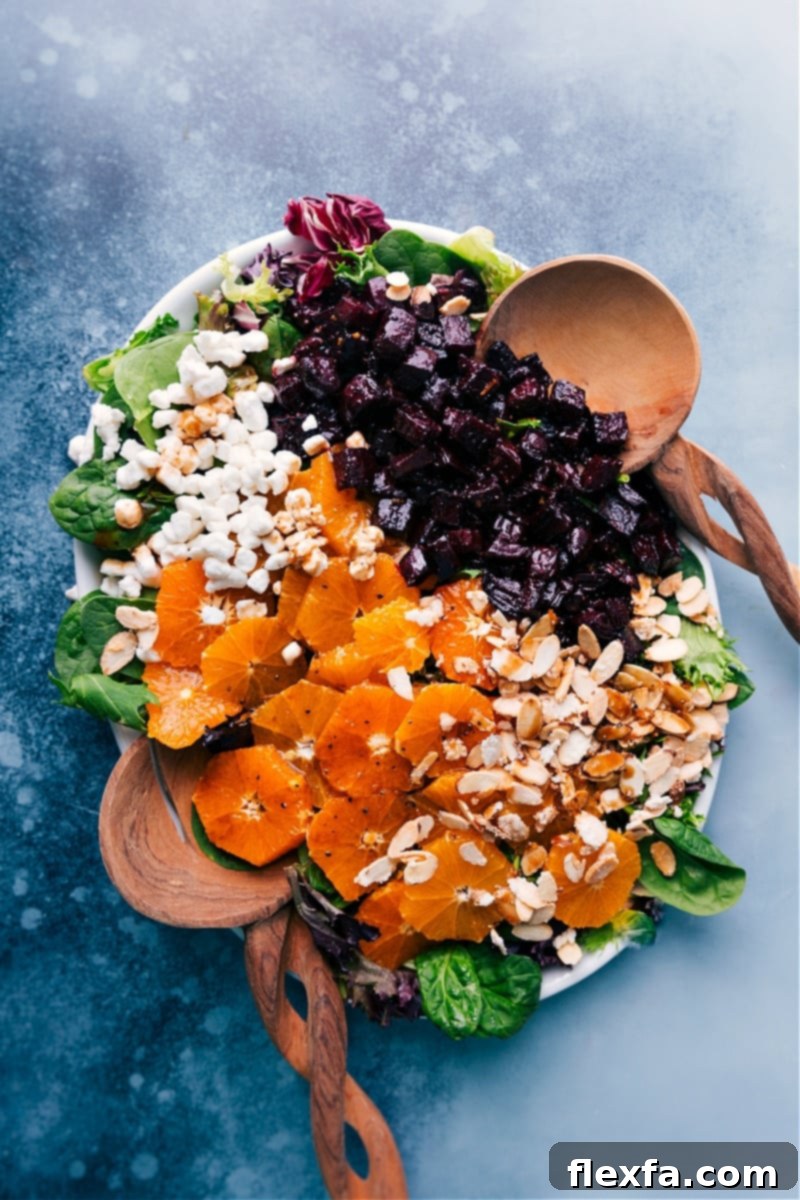 Overhead view of a vibrant Beet Salad with roasted beets, orange segments, goat cheese, and candied almonds.