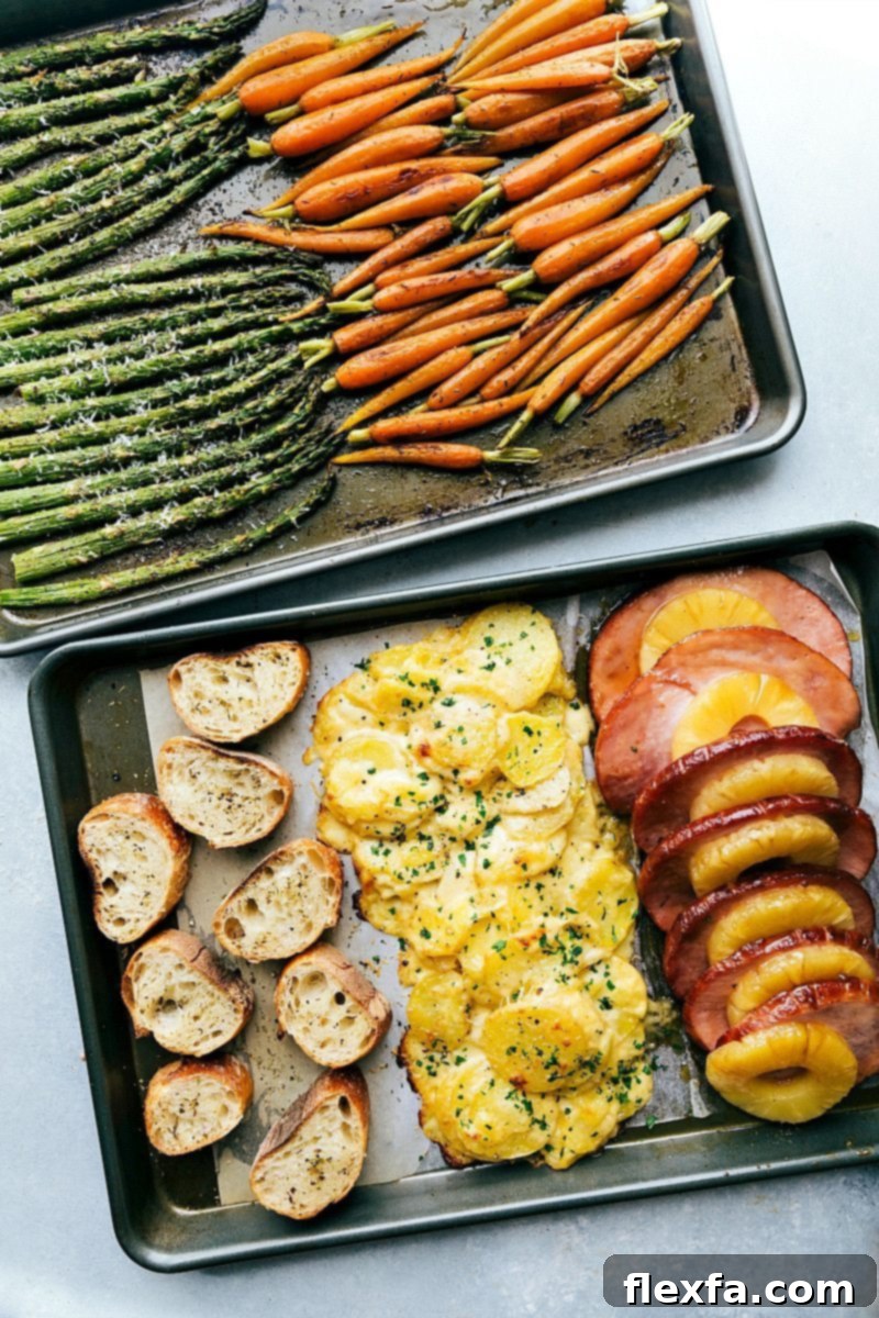 Two sheet pans holding all components of a full Easter dinner, cooked efficiently and ready to serve. An overhead shot showcasing the two sheet pans laden with a complete Easter dinner spread: ham, potatoes, carrots, and asparagus, ready for the oven.