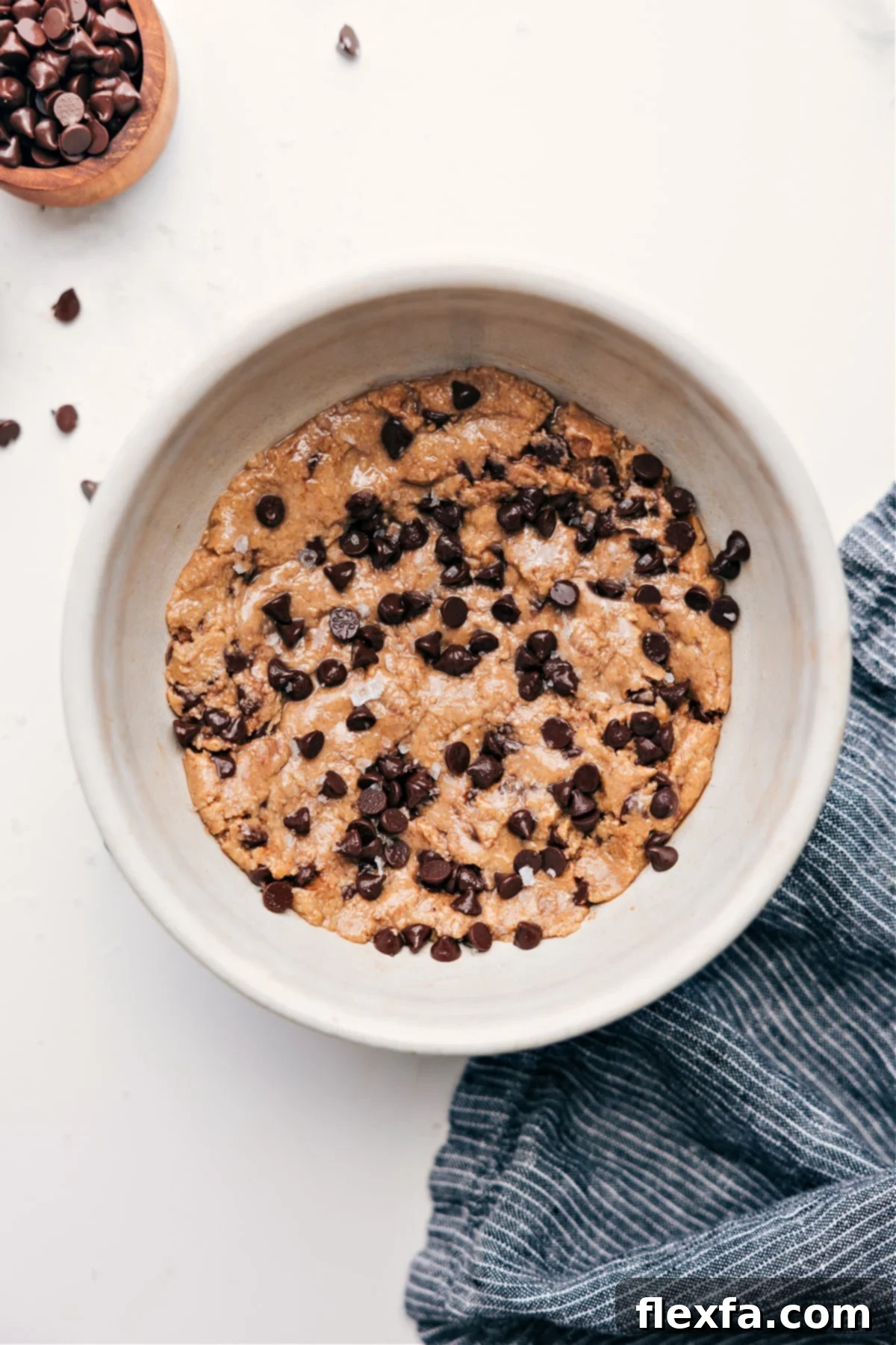 A bowl of delicious chocolate chip protein cookie dough, ready to be enjoyed.