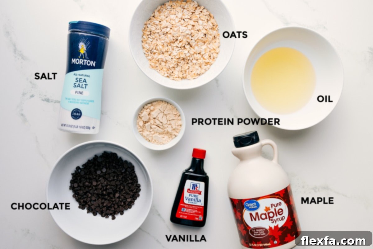 A vibrant flat lay showcasing all the fresh ingredients required for making protein cookie dough: rolled oats, protein powder, coconut oil, maple syrup, vanilla extract, a pinch of salt, and chocolate chips.