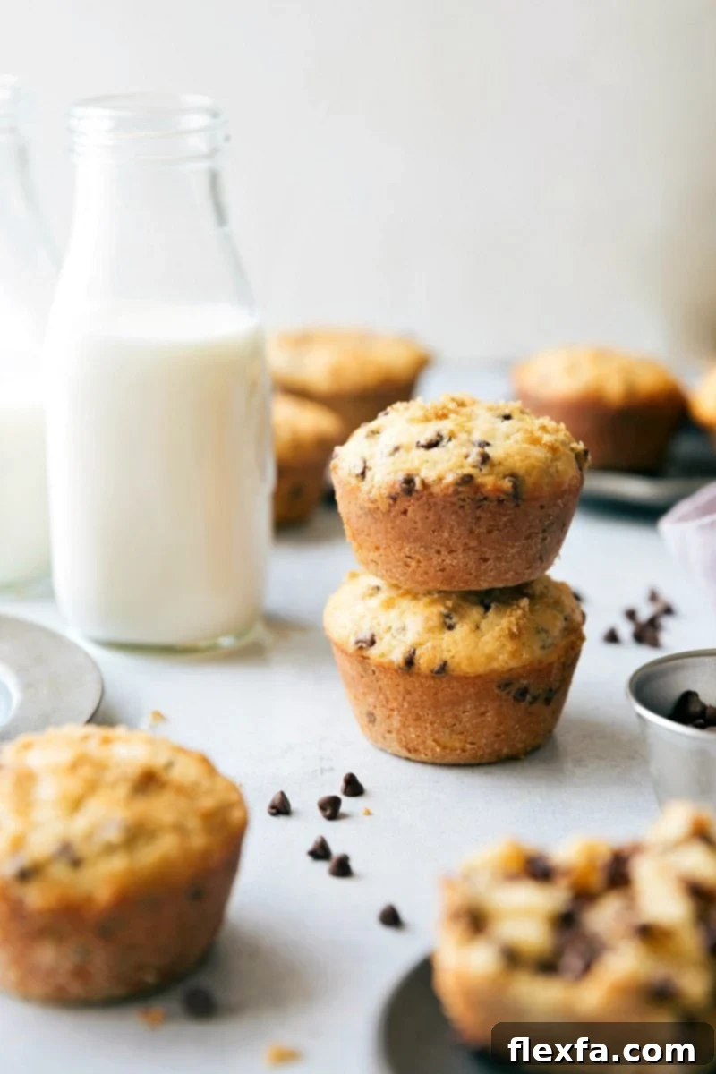 Stacked healthy chocolate chip muffins showcasing their golden-brown tops and rich chocolate chips.