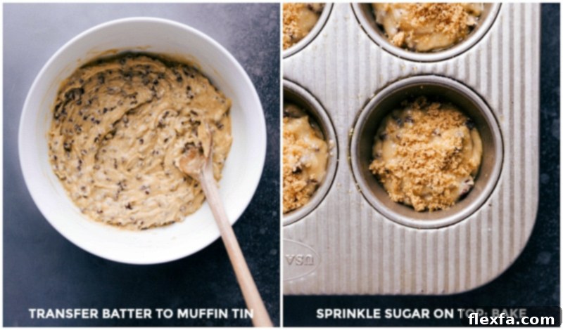 Muffin batter being carefully spooned into a prepared muffin tin before baking.