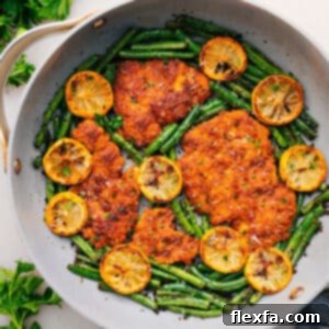 A dish of Lemon Parmesan Chicken with green beans.