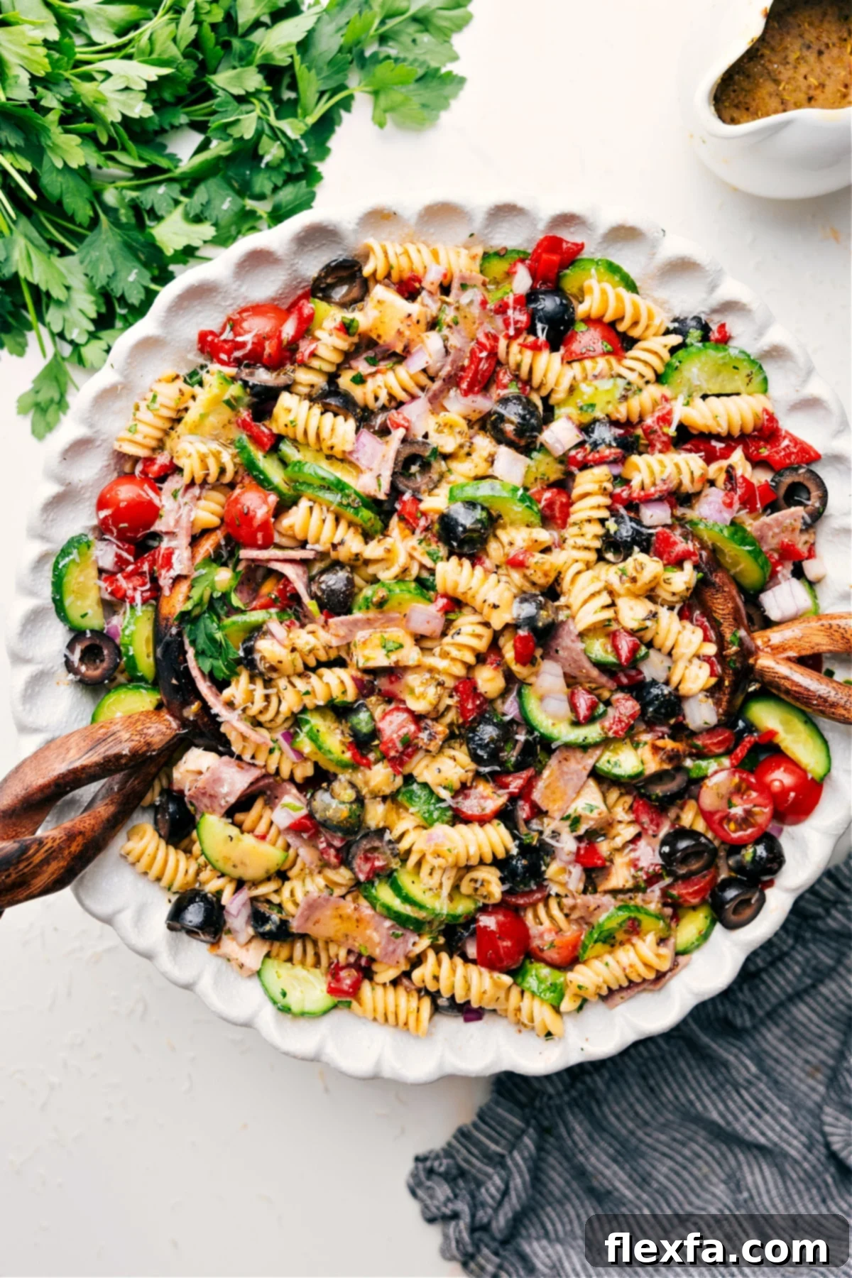 Italian Pasta Salad: The Quintessential Summer Dish A vibrant Italian Pasta Salad, brimming with colorful fresh vegetables, succulent chicken, and a rich, tangy dressing, served in a large bowl, ready for a summer meal.