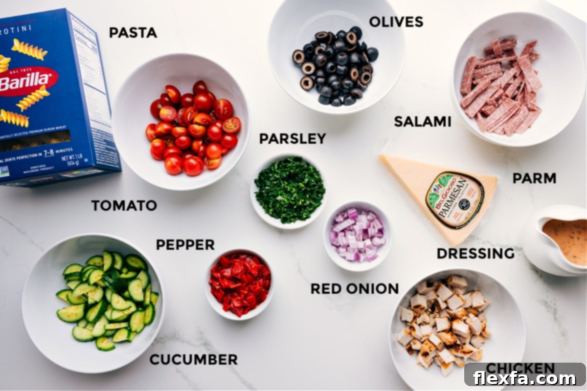 Essential Ingredients for Italian Pasta Salad A beautiful flat lay of all the fresh ingredients for the Italian Pasta Salad, including perfectly cooked rotini pasta, vibrant cherry tomatoes, sliced cucumbers, roasted red peppers, black olives, finely diced red onion, fresh parsley, shredded chicken, thinly sliced salami, and grated Parmesan cheese, neatly arranged with a jar of homemade Italian dressing nearby.