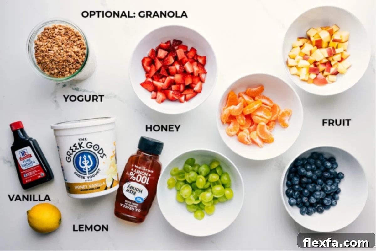 A visual display of all the fresh ingredients meticulously prepped and arranged for making the fruit salad. This includes vibrant strawberries, juicy oranges, crisp apples, plump blueberries, and sweet grapes, alongside a bowl of thick Greek yogurt, golden honey, fragrant vanilla extract, and a fresh lemon half, all ready for easy assembly.