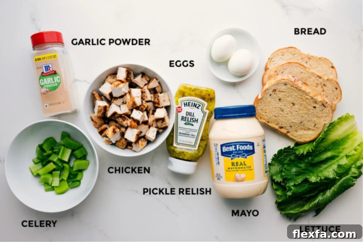 All fresh ingredients for Chick-Fil-A Chicken Salad Recipe prepped and ready on a clean wooden surface, including cooked chicken, crisp celery, a jar of sweet relish, creamy mayonnaise, and peeled hard-boiled eggs, with bread and lettuce in the background.