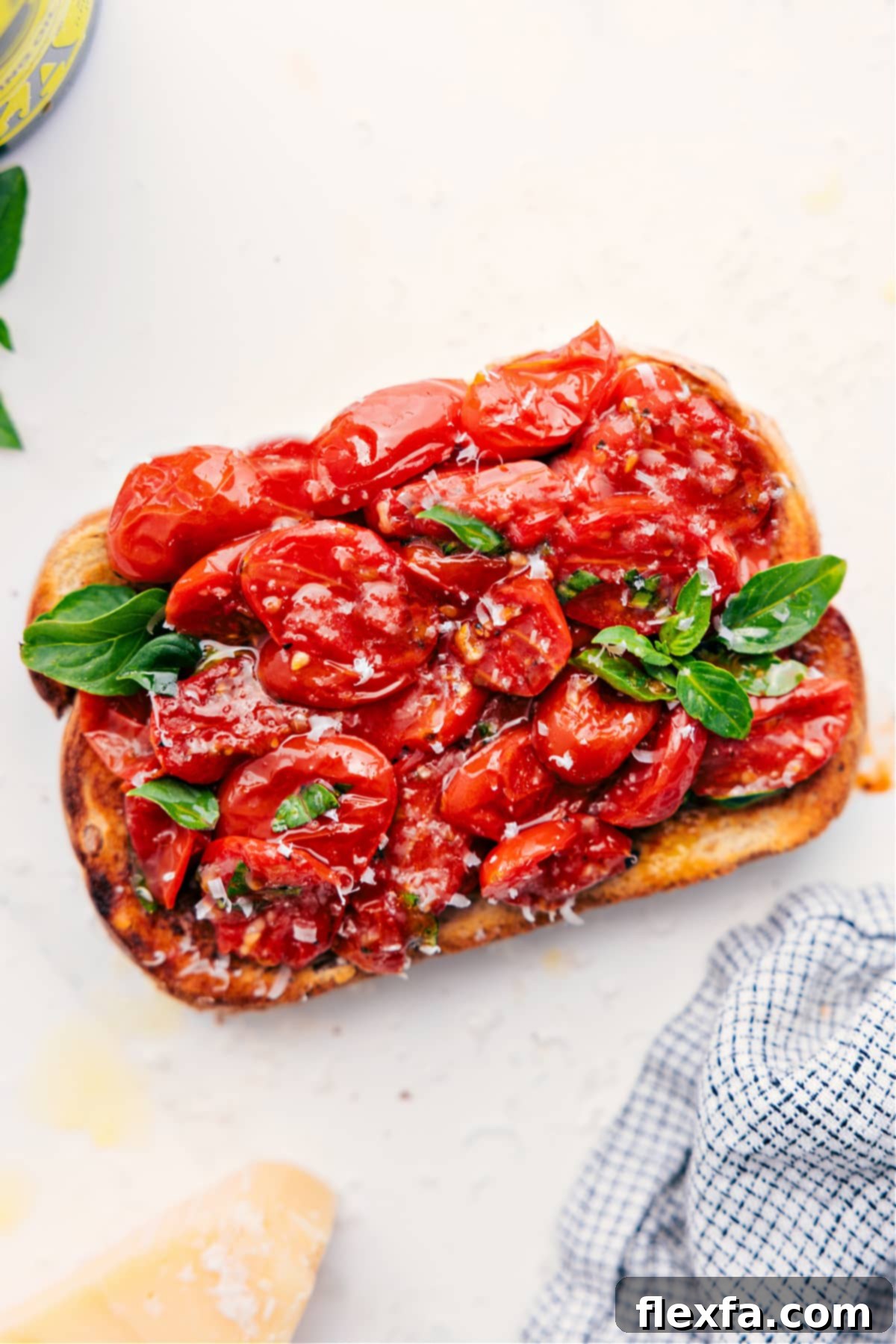 A delicious slice of toast topped with roasted cherry tomatoes, resembling a vibrant bruschetta.