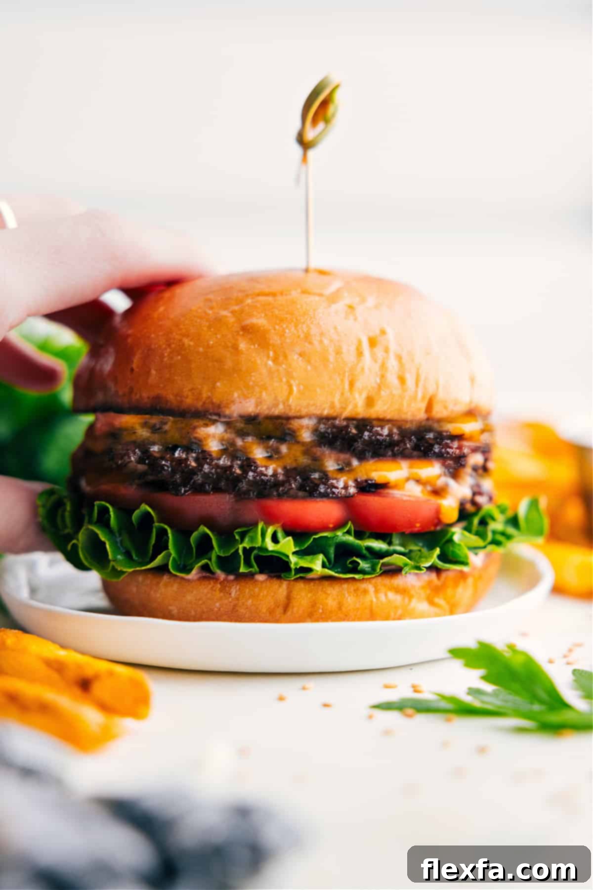The Ultimate Smashburger Recipe Smashburger recipe with lettuce, tomato, cheese, and special sauce in a toasted bun.